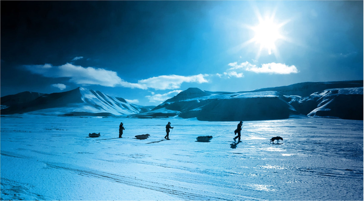 Sled riders walking with their huskies