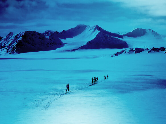 Polar explorers walking over an ice cap